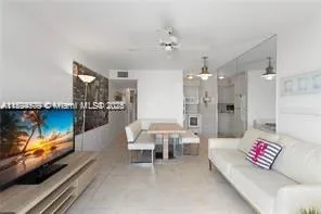 a living room with furniture and a pool table