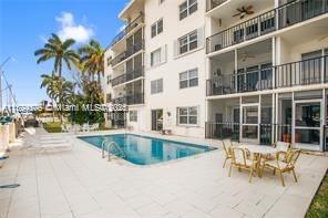 1435 Southeast 15th Street, Unit 103 Fort Lauderdale, FL 33316 - Photo 5 of 33 a view of a swimming pool with a lounge chair