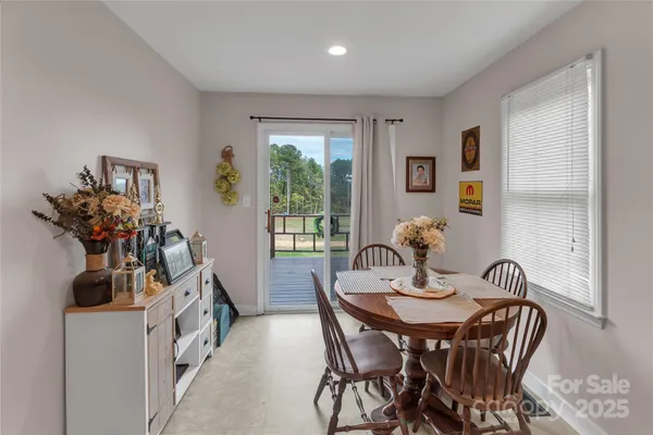 a view of a dining room with furniture and a potted plant