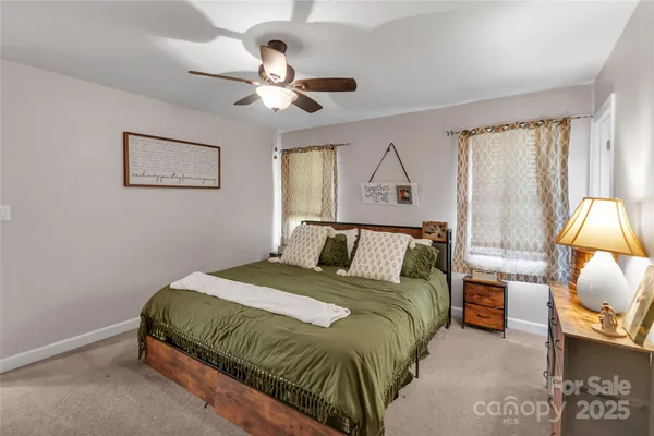 a spacious bathroom with a toilet a sink and a mirror
