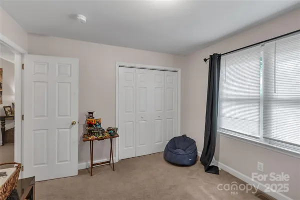 a view of a room with gym equipment and a window