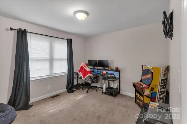 a bedroom with bed and wooden floor