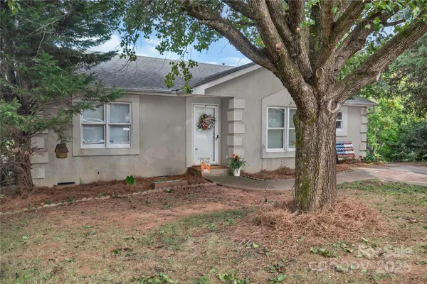 a backyard of a house with table and chairs