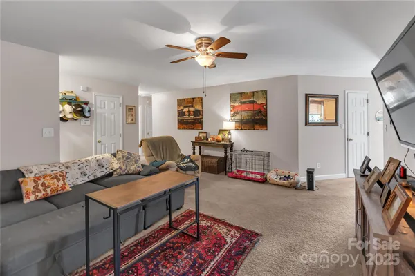 a living room with furniture gym equipment and a flat screen tv