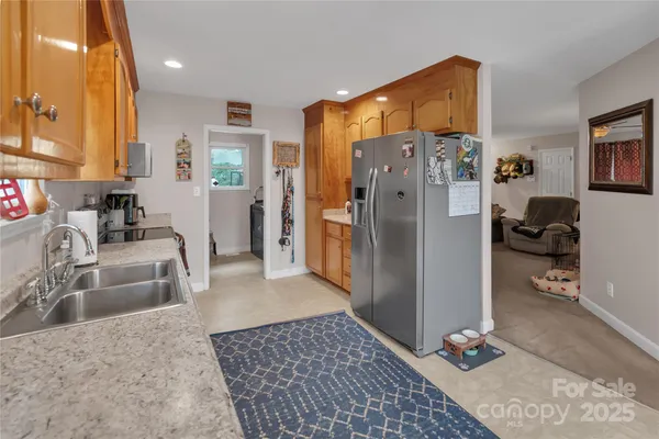 a kitchen with stainless steel appliances granite countertop a refrigerator and a sink