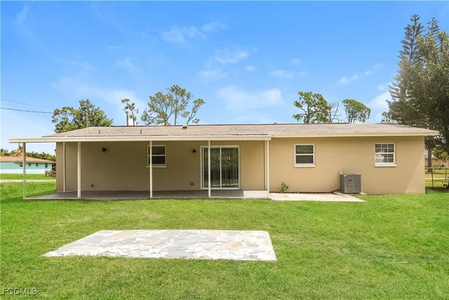 a view of a house with a yard and a garden
