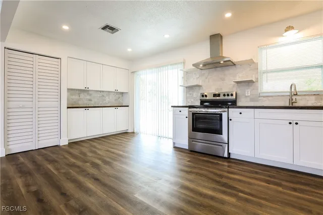a kitchen with stainless steel appliances a stove a sink and a refrigerator