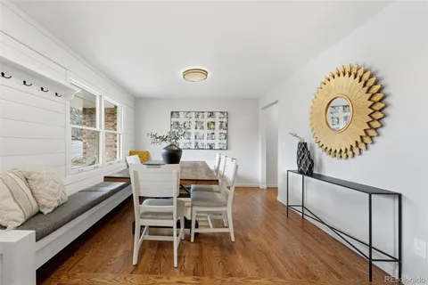 a dining room with furniture and wooden floor