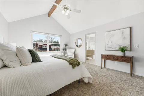 a bedroom with bed and a chandelier