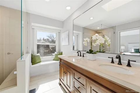a bathroom with a double vanity sink and a large mirror