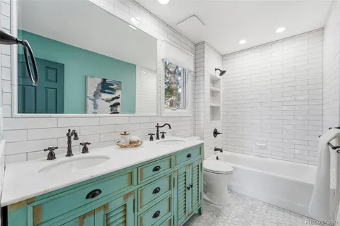 a bathroom with a double vanity sink mirror double and bathtub