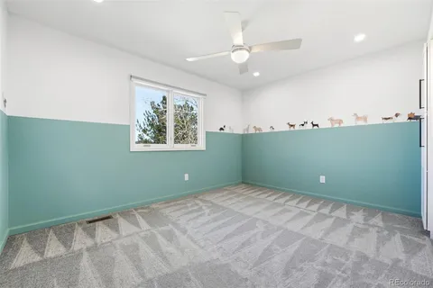 a view of room with window and ceiling fan