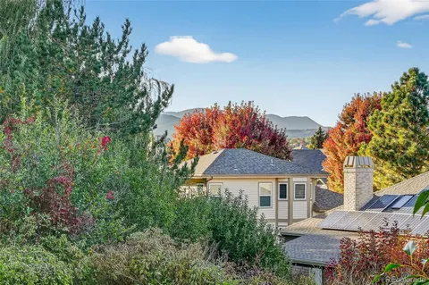 a front view of a house with a yard and tree s