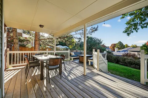 a view of a chairs and table on the wooden deck