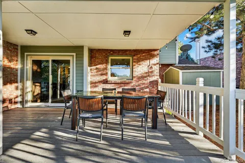a view of a patio with table and chairs and wooden floor
