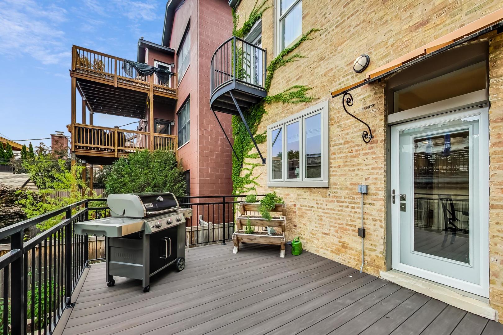 2630 North Racine Avenue Chicago, IL 60614 - Photo 12 of 47 a view of a patio with table and chairs with wooden floor and fence