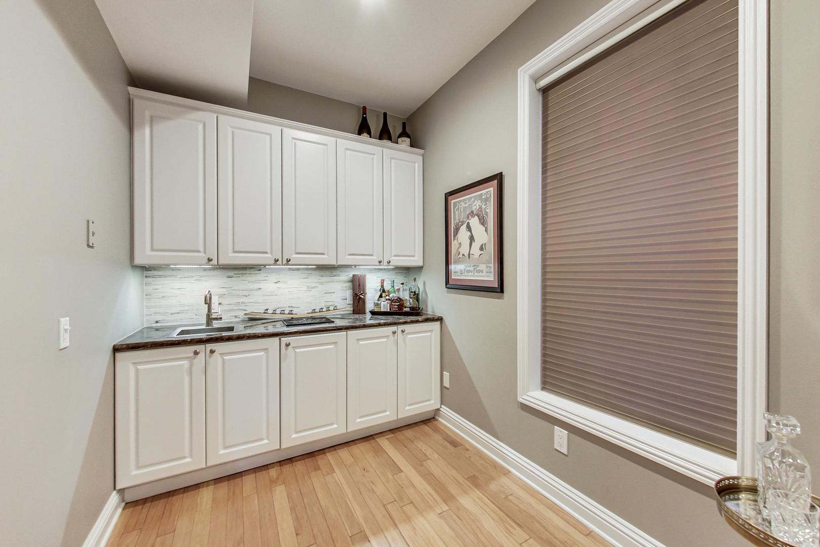2630 North Racine Avenue Chicago, IL 60614 - Photo 16 of 47 a kitchen with granite countertop white cabinets and white appliances