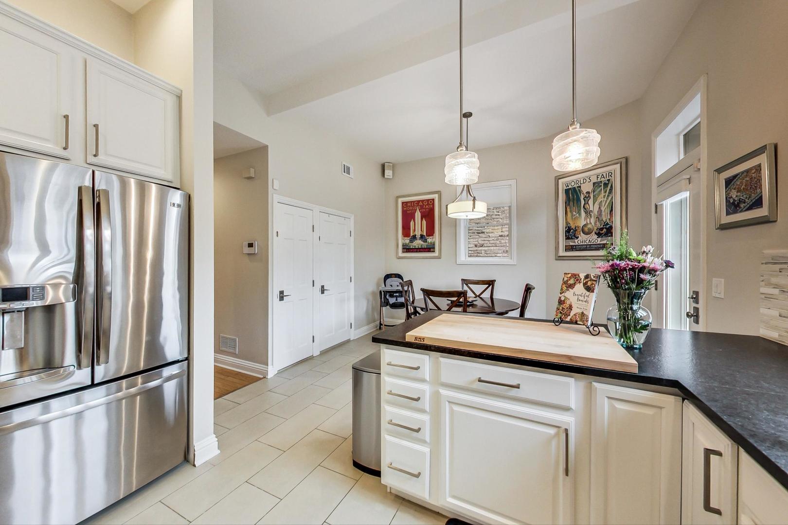 2630 North Racine Avenue Chicago, IL 60614 - Photo 10 of 47 a kitchen with white cabinets and stainless steel appliances