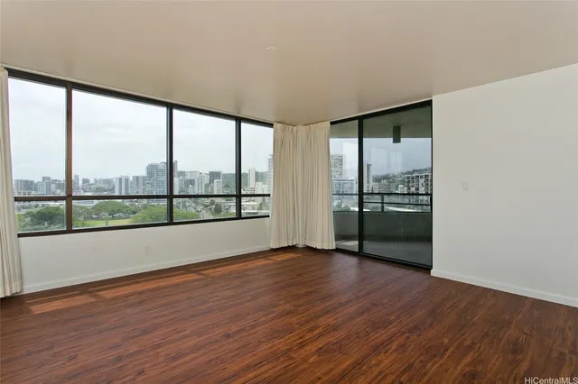 a view of wooden floor and windows in a room
