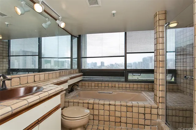 a bathroom with a sink a toilet and mirror