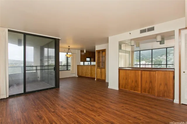 a view of a kitchen with wooden floor and a kitchen