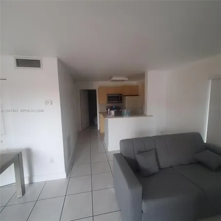 a kitchen with stainless steel appliances a sink stove and refrigerator