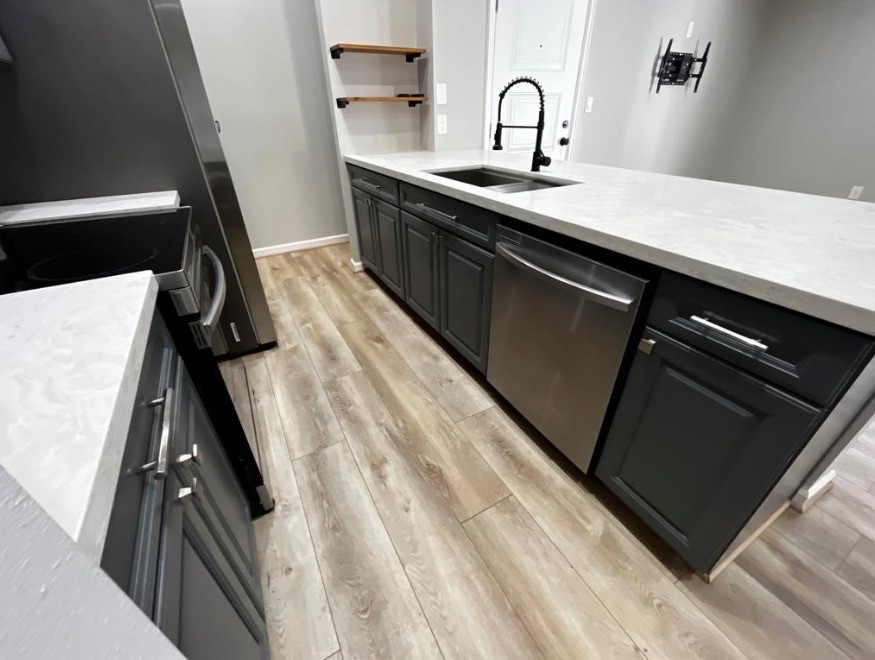 2425 Augusta Drive, Unit 44 Houston, TX 77057 - Photo 13 of 16 a kitchen with a sink and cabinets
