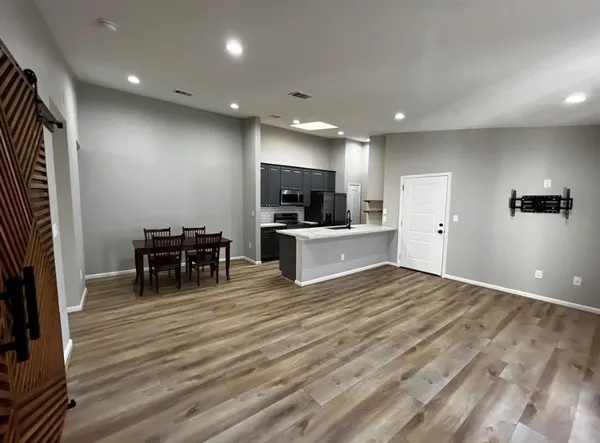a view of kitchen with microwave and cabinets
