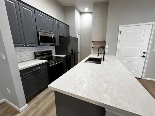 a kitchen with a sink a stove and refrigerator