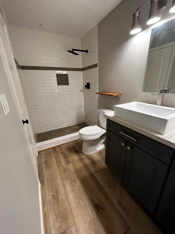 2425 Augusta Drive, Unit 44 Houston, TX 77057 - Photo 8 of 16 a bathroom with a sink a toilet a mirror and shower