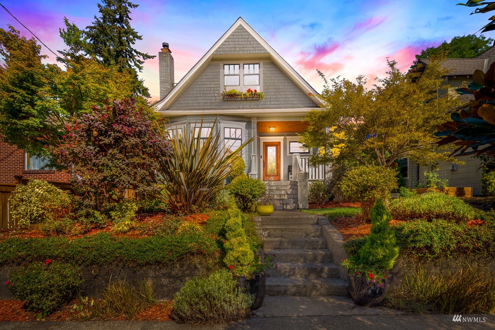 a front view of house along with trees