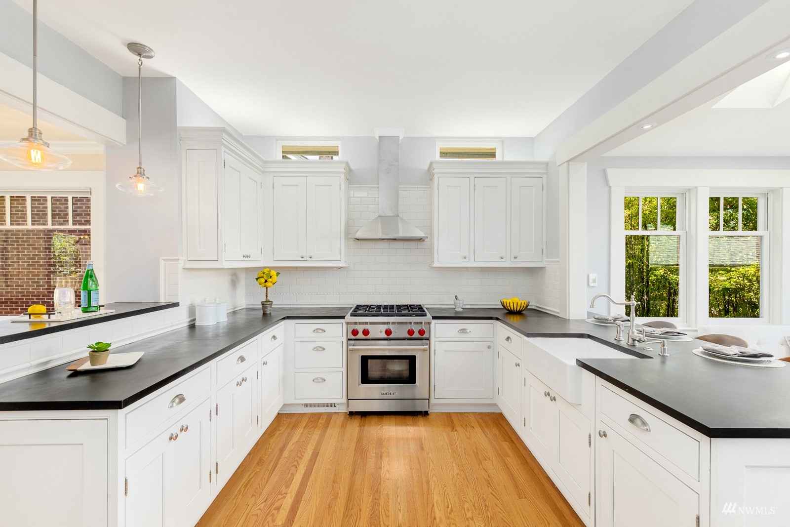 2326 North 59th Street Seattle, WA 98103 - Photo 12 of 38 a kitchen with a sink a stove and cabinets