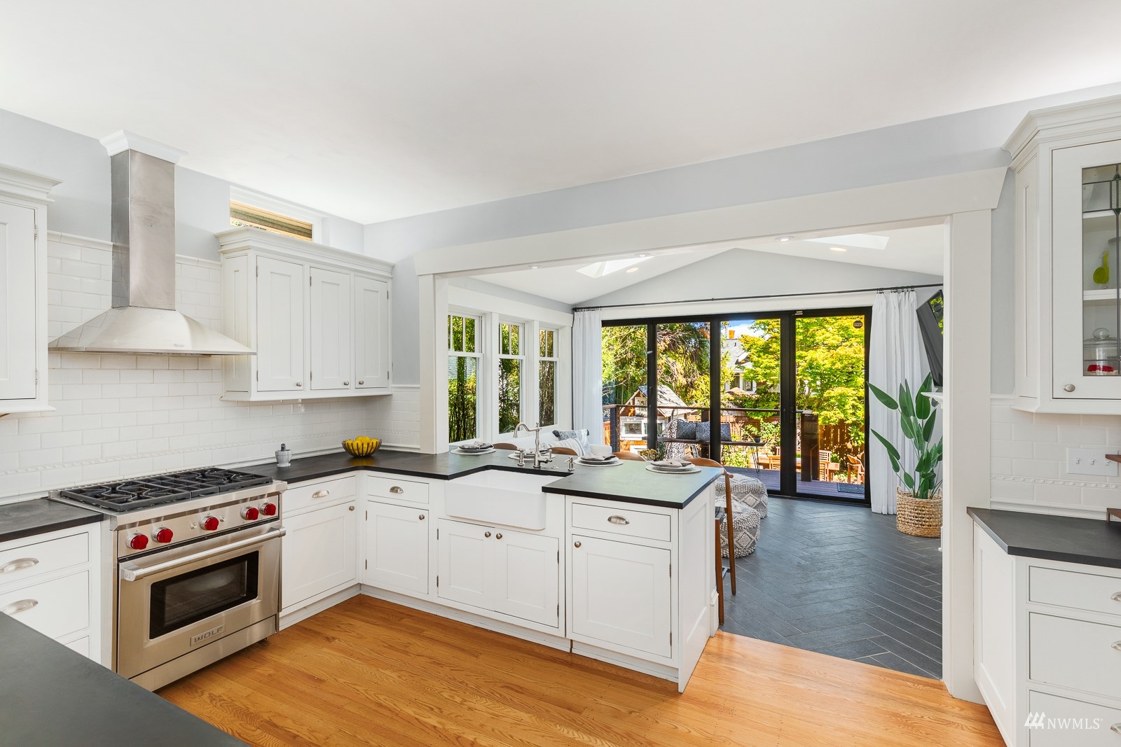 2326 North 59th Street Seattle, WA 98103 - Photo 13 of 38 a kitchen with a sink stove and cabinets