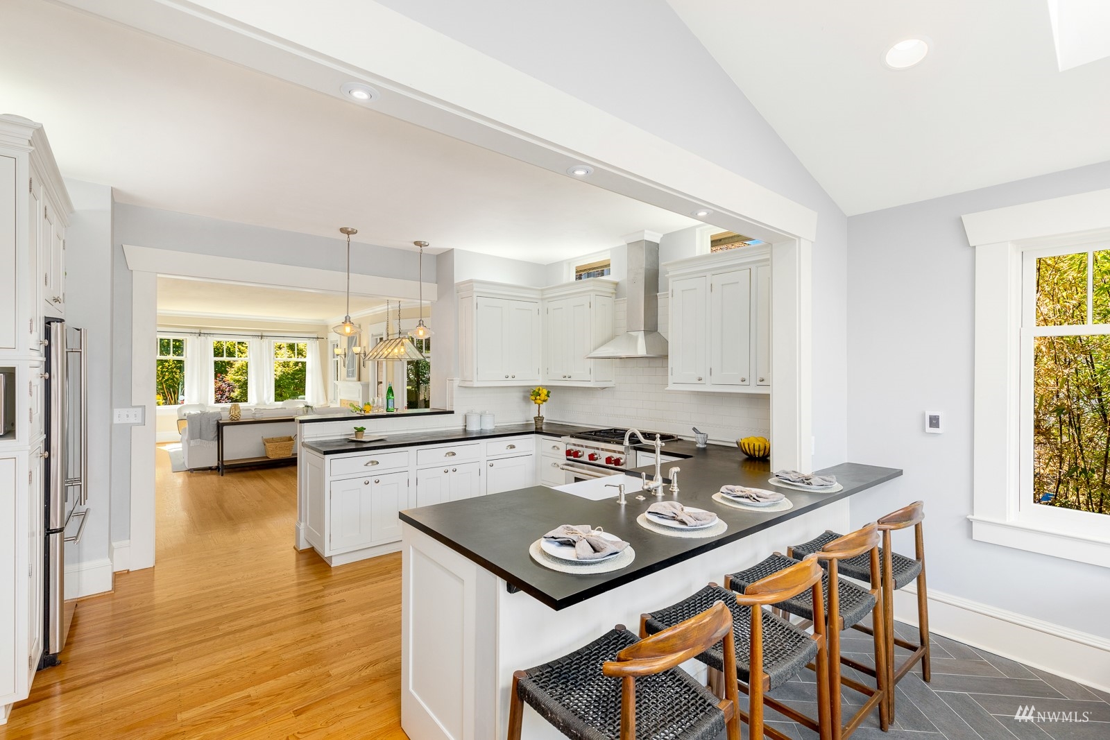 2326 North 59th Street Seattle, WA 98103 - Photo 16 of 38 a kitchen with a table chairs stove a sink and dishwasher