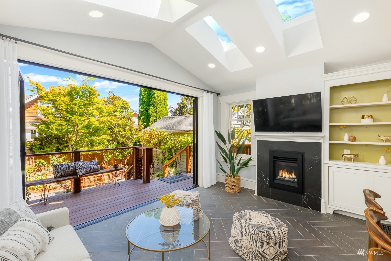 2326 North 59th Street Seattle, WA 98103 - Photo 18 of 38 a living room with furniture a fireplace and a flat screen tv