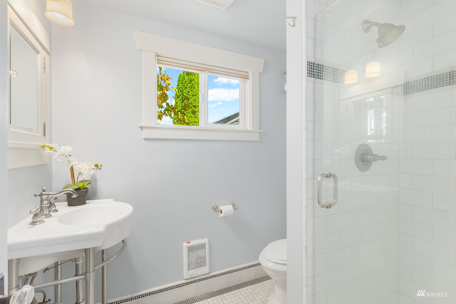 2326 North 59th Street Seattle, WA 98103 - Photo 29 of 38 a bathroom with a sink a toilet and a mirror