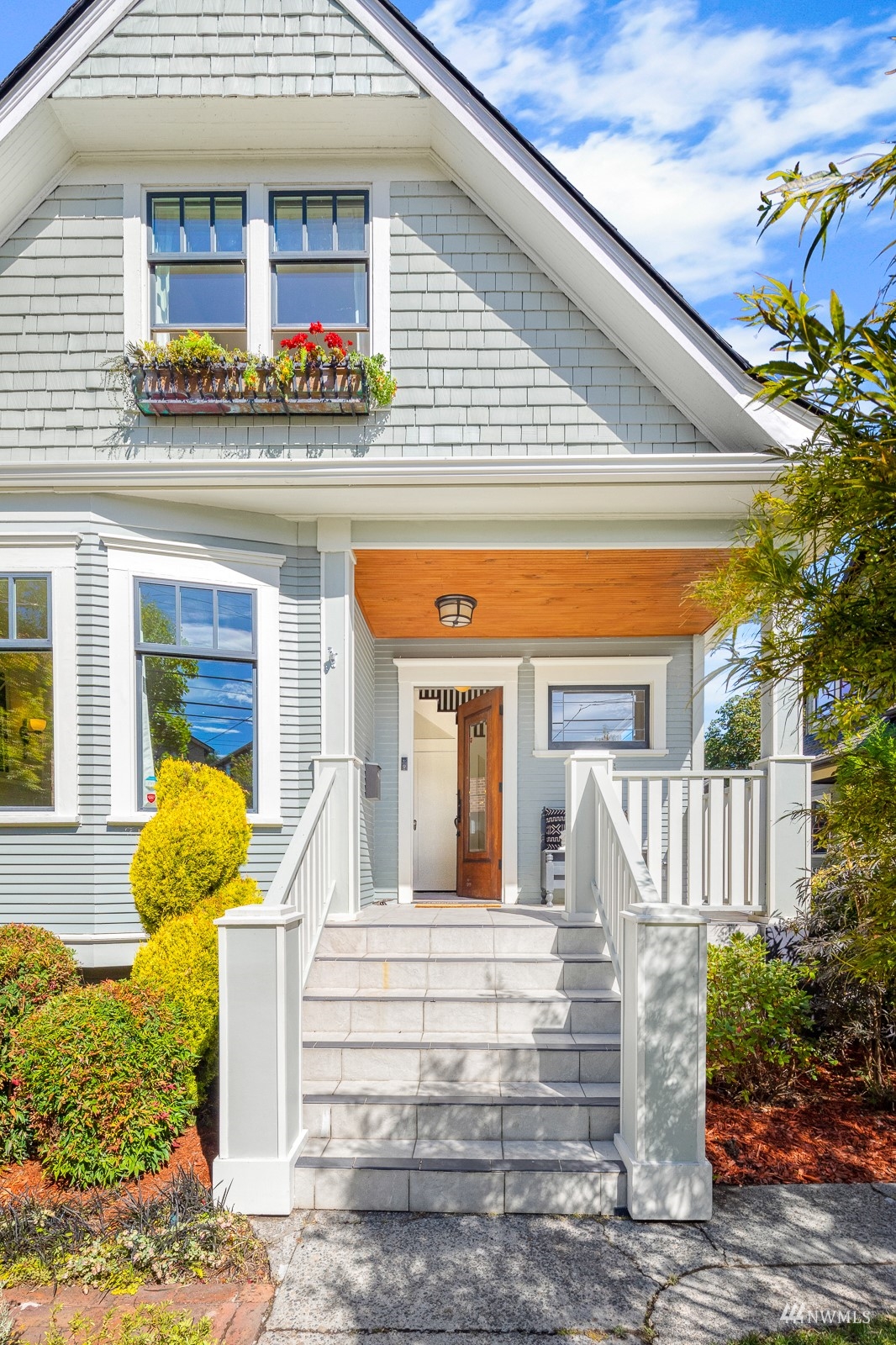 2326 North 59th Street Seattle, WA 98103 - Photo 3 of 38 a front view of a house with a garden