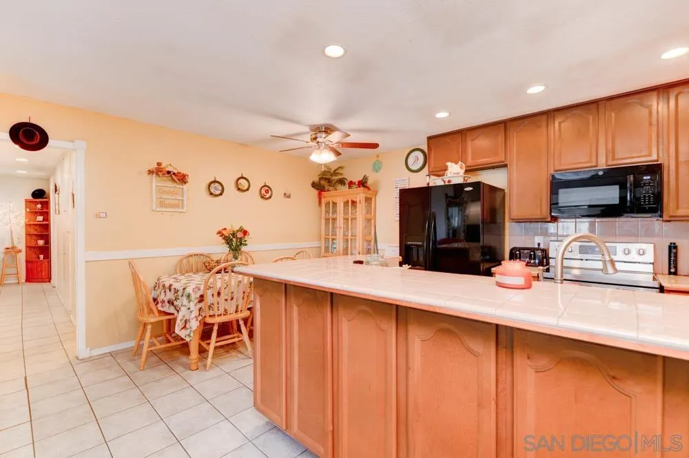 3550 Ruffin Road, Unit 261 San Diego, CA 92123 - Photo 11 of 22 a kitchen with stainless steel appliances kitchen island granite countertop a sink and cabinets