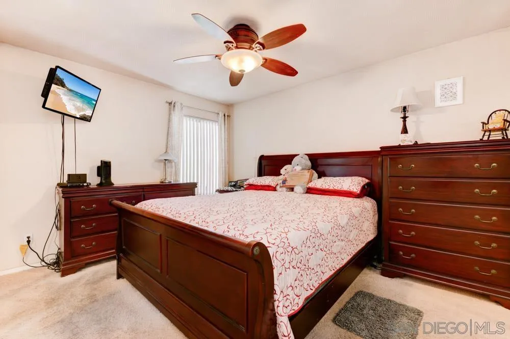 3550 Ruffin Road, Unit 261 San Diego, CA 92123 - Photo 12 of 22 a bedroom with a bed and a chandelier