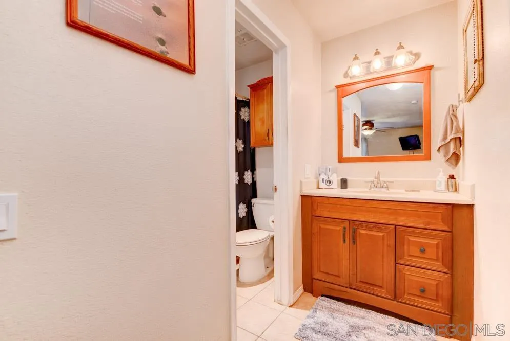 3550 Ruffin Road, Unit 261 San Diego, CA 92123 - Photo 14 of 22 a bathroom with a granite countertop toilet sink and mirror