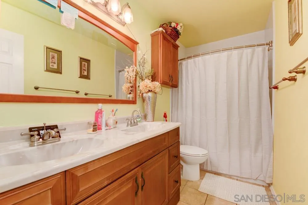 3550 Ruffin Road, Unit 261 San Diego, CA 92123 - Photo 22 of 22 a bathroom with a sink a toilet and a mirror