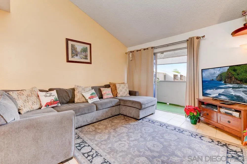 3550 Ruffin Road, Unit 261 San Diego, CA 92123 - Photo 3 of 22 a living room with furniture and a flat screen tv