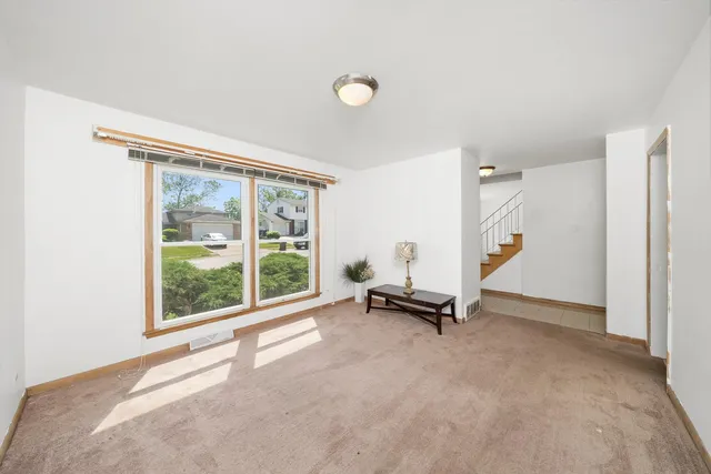 a view of a room with gym equipment and a large window