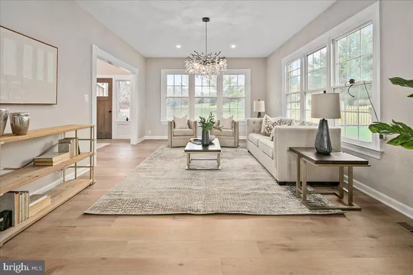 a kitchen with stainless steel appliances granite countertop a refrigerator a sink and white cabinets