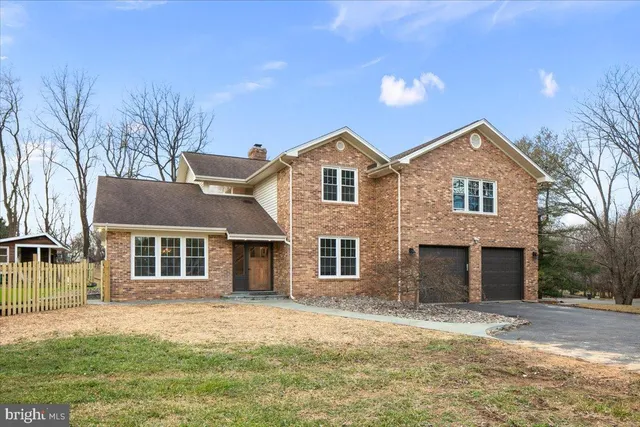 a front view of a house with a garden and yard