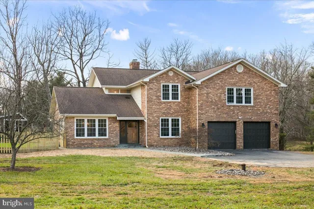 a living room with furniture a chandelier and a rug