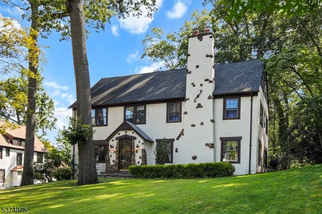 a front view of a house with a garden and plants