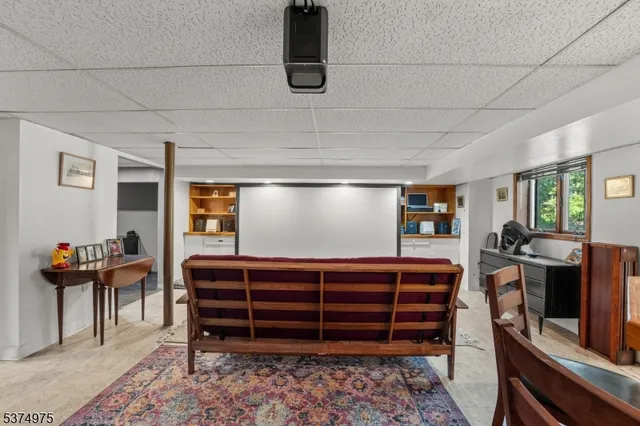 a view of a house with a tree next to a yard