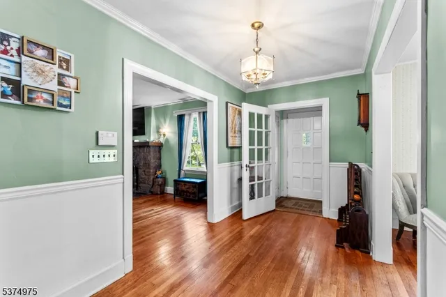 a view of a livingroom with wooden floor and furniture