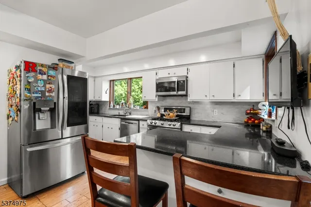 a kitchen with a sink stove top oven and cabinets